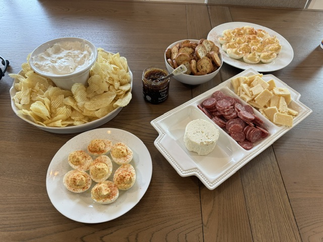 Appetizer spread with deviled eggs, dips, and charcuterie