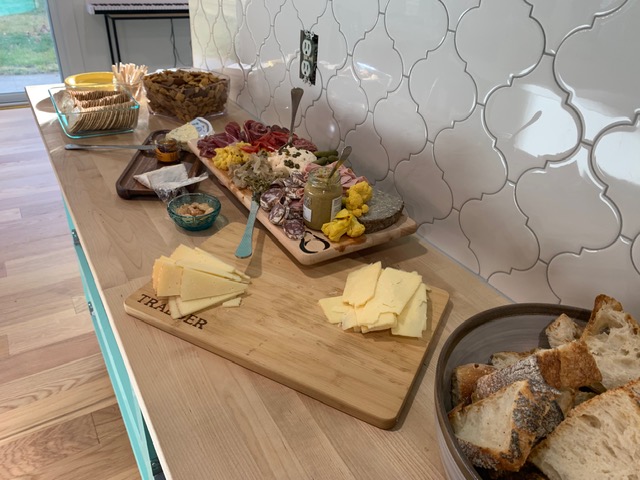 Charcuterie boards with cheeses, cured meats, and fresh bread