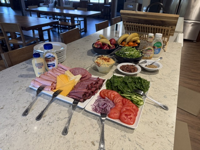 Deli sandwich spread with meats, cheeses, and fixings