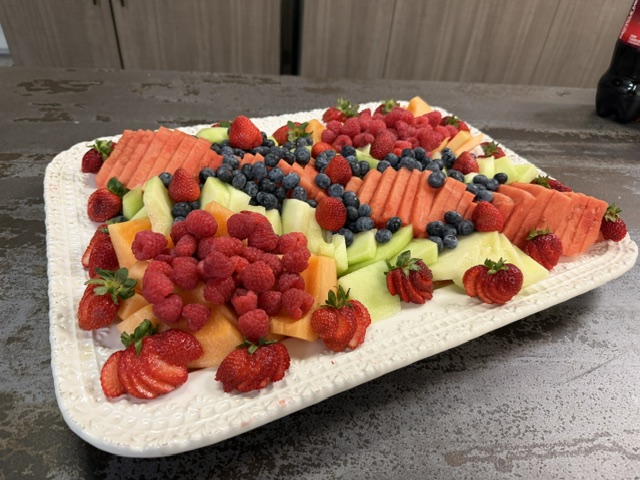 Hand-arranged fresh fruit platter with berries and melon