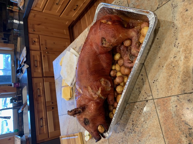 Whole roasted pig with potatoes